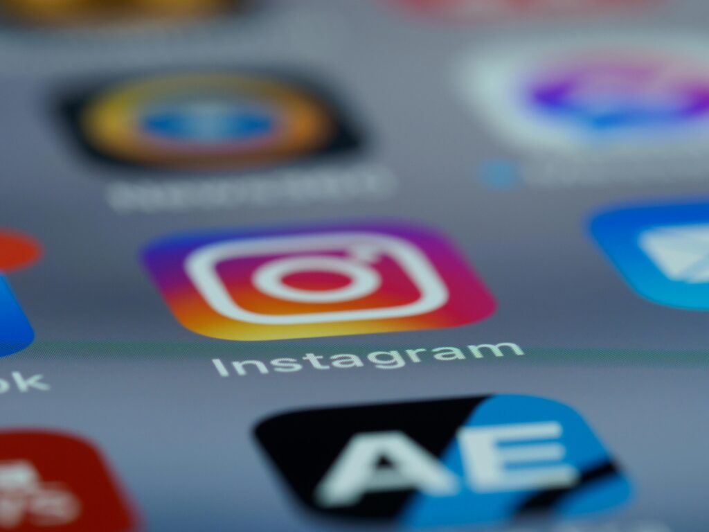 You Post Every Day and Don't Sell Anything? Discover What's Wrong (and How to Fix It) Instagram app icon in focus on a smartphone screen, blurred background.