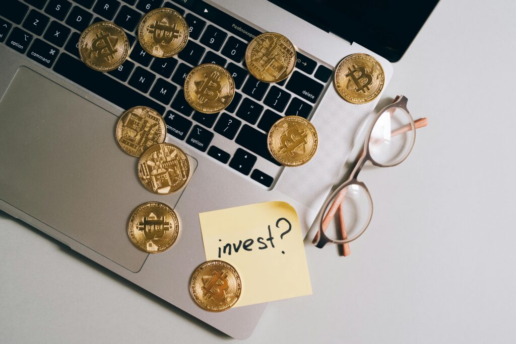 Laptop with Bitcoin coins, eyeglasses, and 